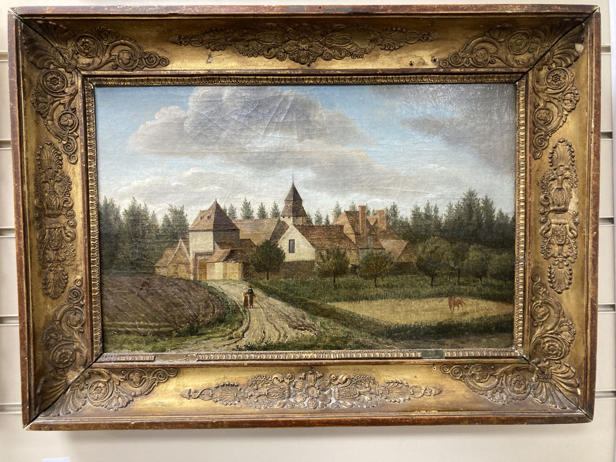 19th century Continental School, oil on canvas, View of a village with figures and a horse in the foreground, 29 x 45cm